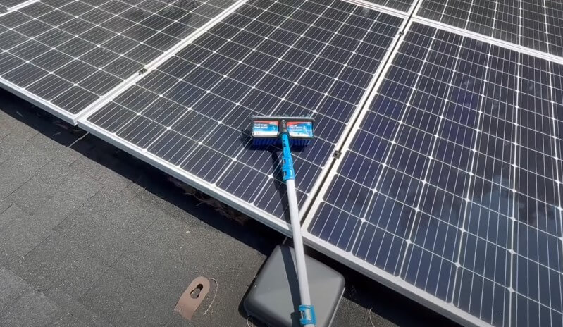 A brush is cleaning solar panel